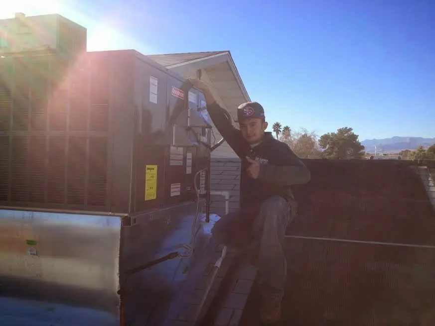 HVAC technician performing HVAC Inspection on a rooftop unit in El Sobrante